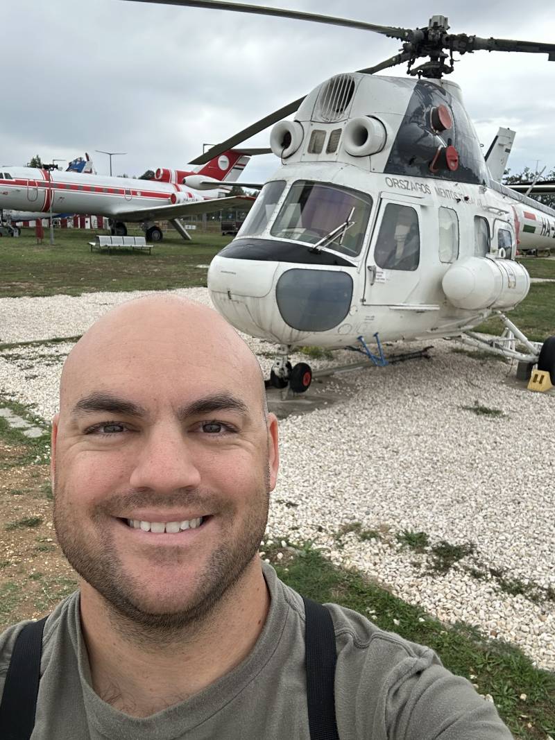 A picture of me in front of a really cool helicopter at an aviation museum in Budapest, Hungary